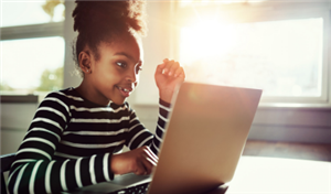  A young girl using a laptop computer